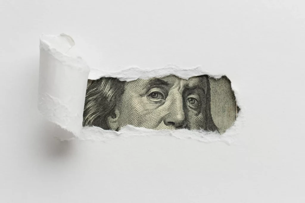 ripped-paper-revealing-dollar-bill